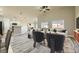 Bright, staged living room with hardwood floors, modern furnishings, and an adjacent kitchen at 5817 Pirate Ship Dr, North Las Vegas, NV 89031