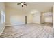Spacious living room with wood flooring, neutral walls, and a ceiling fan at 5817 Pirate Ship Dr, North Las Vegas, NV 89031