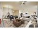 Bright, staged open-concept living area with hardwood floors, modern furnishings, kitchen, and dining at 5817 Pirate Ship Dr, North Las Vegas, NV 89031