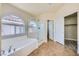Luxurious main bathroom with separate tub and shower, along with a walk-in closet, offering ultimate comfort at 5817 Pirate Ship Dr, North Las Vegas, NV 89031