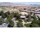 A beautiful aerial view of a community, clubhouse and golf course against a scenic mountain backdrop at 5918 Terra Grande Ave, Las Vegas, NV 89122