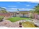 Backyard with synthetic grass, patio, and a rock-lined pond feature at 5918 Terra Grande Ave, Las Vegas, NV 89122
