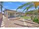 Backyard featuring low-maintenance gravel landscaping and a synthetic grass lawn at 5918 Terra Grande Ave, Las Vegas, NV 89122
