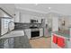 Well-lit kitchen with stainless steel appliances, granite countertops, and white cabinets at 5918 Terra Grande Ave, Las Vegas, NV 89122