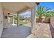 Inviting covered patio with brick flooring and view of the landscaped backyard at 5918 Terra Grande Ave, Las Vegas, NV 89122
