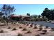 Street view of a community entrance with desert landscaping, a guard house and mountain backdrop at 5918 Terra Grande Ave, Las Vegas, NV 89122