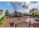 Spacious backyard featuring multiple seating areas, mature landscaping, and charming decor elements at 6536 Pleasant Plains Way, Las Vegas, NV 89108