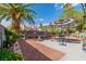 Spacious backyard featuring landscaping, shade umbrellas, and a patio area for outdoor dining at 6536 Pleasant Plains Way, Las Vegas, NV 89108
