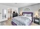 Bedroom with en-suite bathroom, dresser, and decorative wall art at 6536 Pleasant Plains Way, Las Vegas, NV 89108