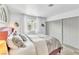 Bedroom with sliding door closet, a decorative headboard, and natural light at 6536 Pleasant Plains Way, Las Vegas, NV 89108