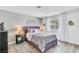 Cozy bedroom with a purple bedframe, decorative headboard, and natural light at 6536 Pleasant Plains Way, Las Vegas, NV 89108