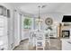 Cozy dining area featuring a white table set, modern chandelier, and abundant natural light at 6536 Pleasant Plains Way, Las Vegas, NV 89108