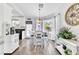 Bright dining area with white furniture and a view of the backyard through a bay window at 6536 Pleasant Plains Way, Las Vegas, NV 89108