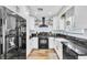 Modern kitchen with stainless steel appliances, black marble countertops, and white cabinets at 6536 Pleasant Plains Way, Las Vegas, NV 89108