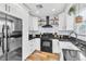 Modern kitchen with white cabinets, black countertops, and stainless steel refrigerator at 6536 Pleasant Plains Way, Las Vegas, NV 89108