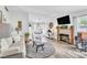 Bright living room featuring hardwood floors, a fireplace, and lots of natural light at 6536 Pleasant Plains Way, Las Vegas, NV 89108