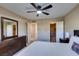 Bright bedroom with neutral walls, ceiling fan, dresser, walk-in closet and a lovely ensuite bathroom at 668 Oakmont Ave # 1715, Las Vegas, NV 89109