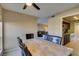 Open-concept dining area with a marble-top table and leather chairs adjacent to the kitchen and living room at 668 Oakmont Ave # 1715, Las Vegas, NV 89109