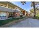 Building exterior shows brick facade, multiple units, landscaped patio areas, and mature trees at 668 Oakmont Ave # 1715, Las Vegas, NV 89109