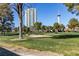 Golf course view showcases sand trap, mature trees, city buildings and clear blue sky at 668 Oakmont Ave # 1715, Las Vegas, NV 89109