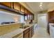 The kitchen has granite counters, stainless steel appliances, and a convenient breakfast bar overlooking the living room at 668 Oakmont Ave # 1715, Las Vegas, NV 89109