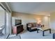 Comfortable living room with sofa, TV, neutral carpet and sliding glass doors to a patio at 668 Oakmont Ave # 1715, Las Vegas, NV 89109