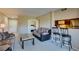Relaxing living space with bar seating, plush sofas, and an adjacent bedroom at 668 Oakmont Ave # 1715, Las Vegas, NV 89109