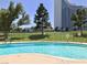 Inviting community pool with clear blue water and well-maintained green space, perfect for relaxation at 668 Oakmont Ave # 1715, Las Vegas, NV 89109