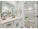 Bathroom with marble floors, bright vanity area, and glass shower stall at 709 Pickled Pepper Pl, Henderson, NV 89011