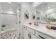 Bright bathroom with white cabinets and marble floors featuring large mirrors and shower at 709 Pickled Pepper Pl, Henderson, NV 89011