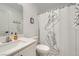 Bathroom with modern sneakers shower curtain, decor, and lighting at 709 Pickled Pepper Pl, Henderson, NV 89011