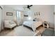 Bright bedroom with wood floors, natural light, comfortable chair, and decorative accents at 709 Pickled Pepper Pl, Henderson, NV 89011