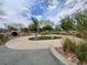 Stroll down the walking path in the community space, lined with rocks and mature landscaping at 709 Pickled Pepper Pl, Henderson, NV 89011
