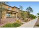 Charming townhouse with a covered porch, stone accents, and well-maintained landscaping on a quiet street at 709 Pickled Pepper Pl, Henderson, NV 89011