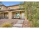 Attractive two-story townhouse with a covered porch, stone detailing, and inviting entryway on a sunny day at 709 Pickled Pepper Pl, Henderson, NV 89011