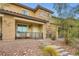 Beautifully landscaped townhouse with a covered porch, stone accents, and a welcoming entrance for guests at 709 Pickled Pepper Pl, Henderson, NV 89011