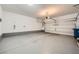Spacious garage with epoxy flooring, overhead lighting, and ample room for parking and storage at 709 Pickled Pepper Pl, Henderson, NV 89011