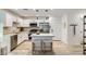 Modern kitchen with white cabinets, stainless steel appliances, and an island with comfortable barstool seating at 709 Pickled Pepper Pl, Henderson, NV 89011