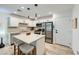 Well-lit kitchen featuring white cabinets, stainless steel appliances, and an island with barstool seating at 709 Pickled Pepper Pl, Henderson, NV 89011
