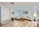 Inviting living room with wood floors, large sectional, and a view of the front door and artwork at 709 Pickled Pepper Pl, Henderson, NV 89011
