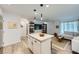 Open floor plan featuring a modern kitchen with island flowing into a living area with a comfortable sectional at 709 Pickled Pepper Pl, Henderson, NV 89011