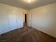 This bedroom has neutral carpet and paint with closet and doorway at 8704 Autumn Wreath Ave, Las Vegas, NV 89129