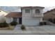Charming two-story home with a terracotta roof, a balcony, a two-car garage, and a well-maintained front yard at 8704 Autumn Wreath Ave, Las Vegas, NV 89129