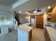 Bright kitchen with white appliances, tiled countertops and floors, plus wooden cabinets at 8704 Autumn Wreath Ave, Las Vegas, NV 89129