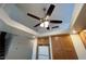 A kitchen with wood cabinets and a ceiling fan/light with a skylight at 8704 Autumn Wreath Ave, Las Vegas, NV 89129