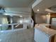Bright open floorplan showcasing kitchen and living room with fireplace and large windows at 8704 Autumn Wreath Ave, Las Vegas, NV 89129