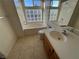 Bright main bathroom featuring a soaking tub, shower, vanity, and tiled floors at 8704 Autumn Wreath Ave, Las Vegas, NV 89129