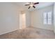 Neutral carpeted bedroom featuring a shuttered window and lots of natural light at 8732 Kendall Brook Cir, Las Vegas, NV 89149