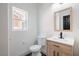 Bathroom featuring neutral walls, tile floor, wood vanity, and a framed mirror at 8798 Tom Noon Ave # 103, Las Vegas, NV 89178