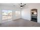 Bright main bedroom with neutral carpet, ceiling fan, and adjoining en suite bathroom at 8798 Tom Noon Ave # 103, Las Vegas, NV 89178